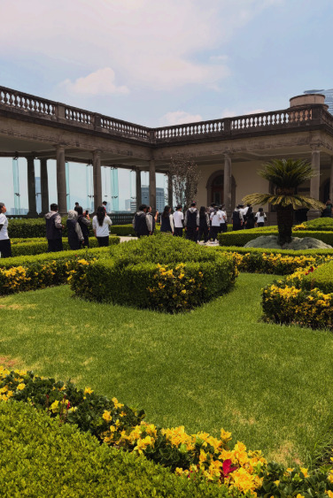 Guided tour group at Chapultepec Castle with families and children